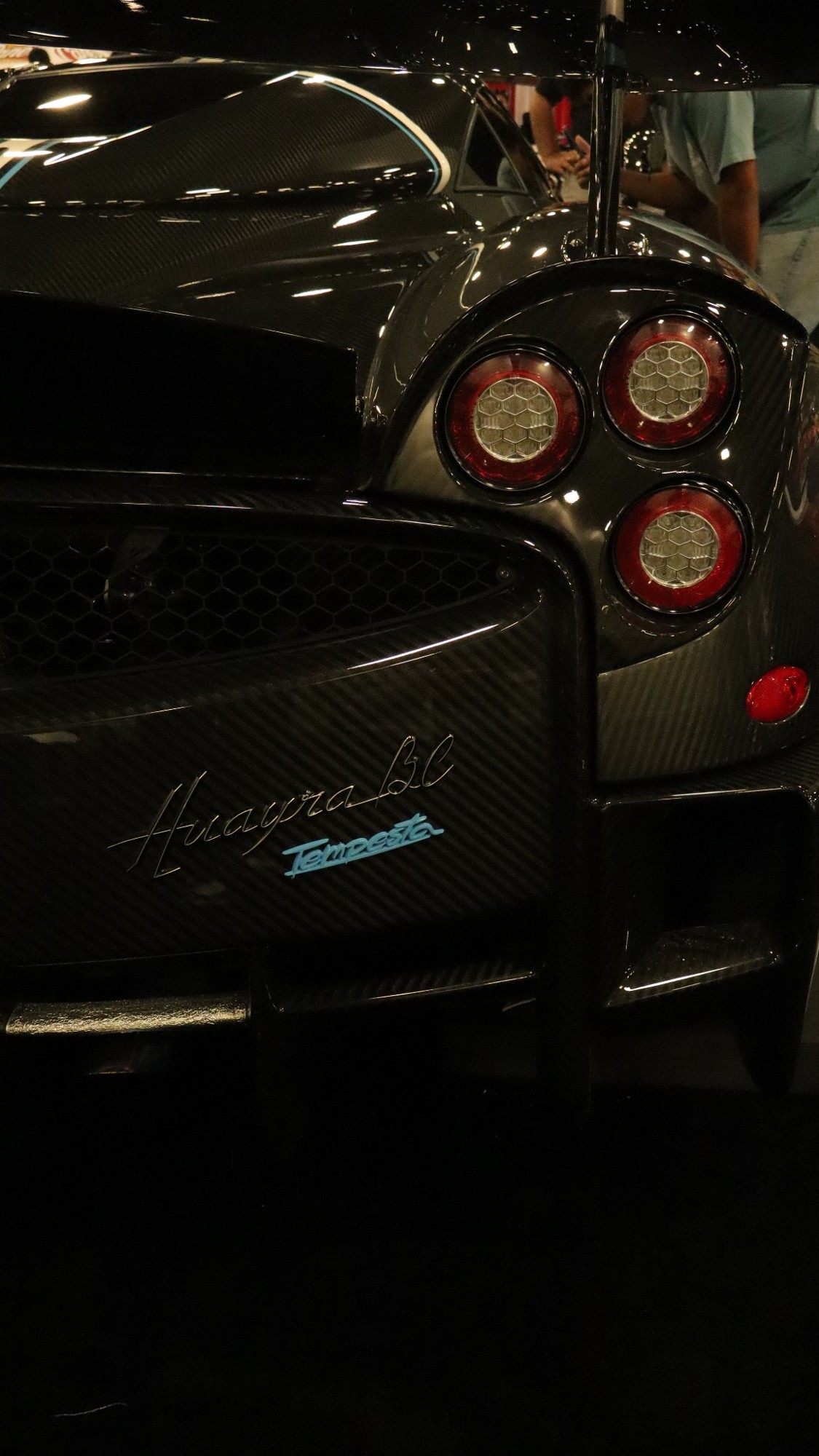 Rear lights and carbon-fiber details of a supercar at night