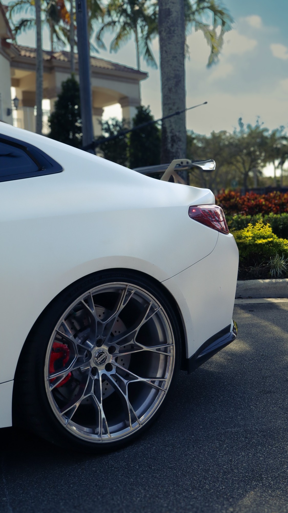 White coupe rear quarter with multi-spoke wheel