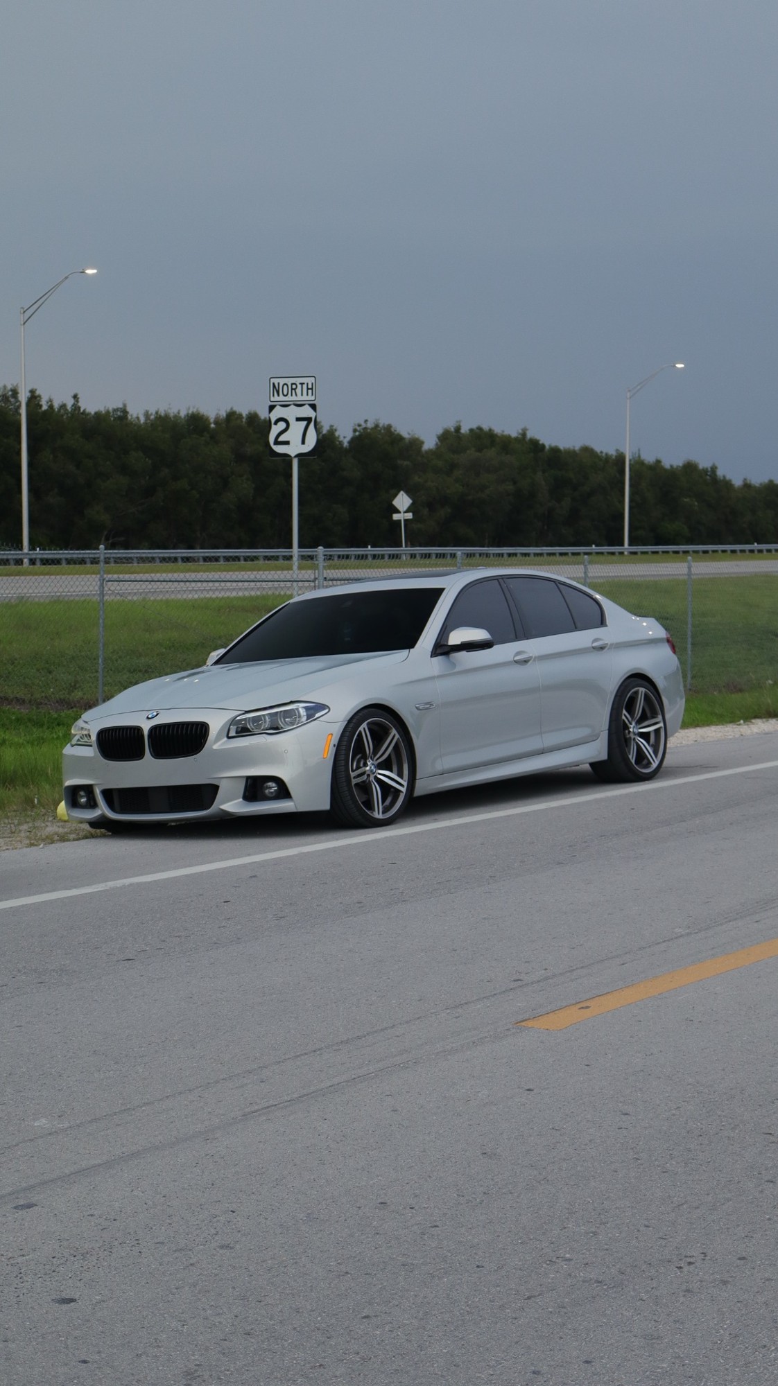 White BMW photographed on the road
