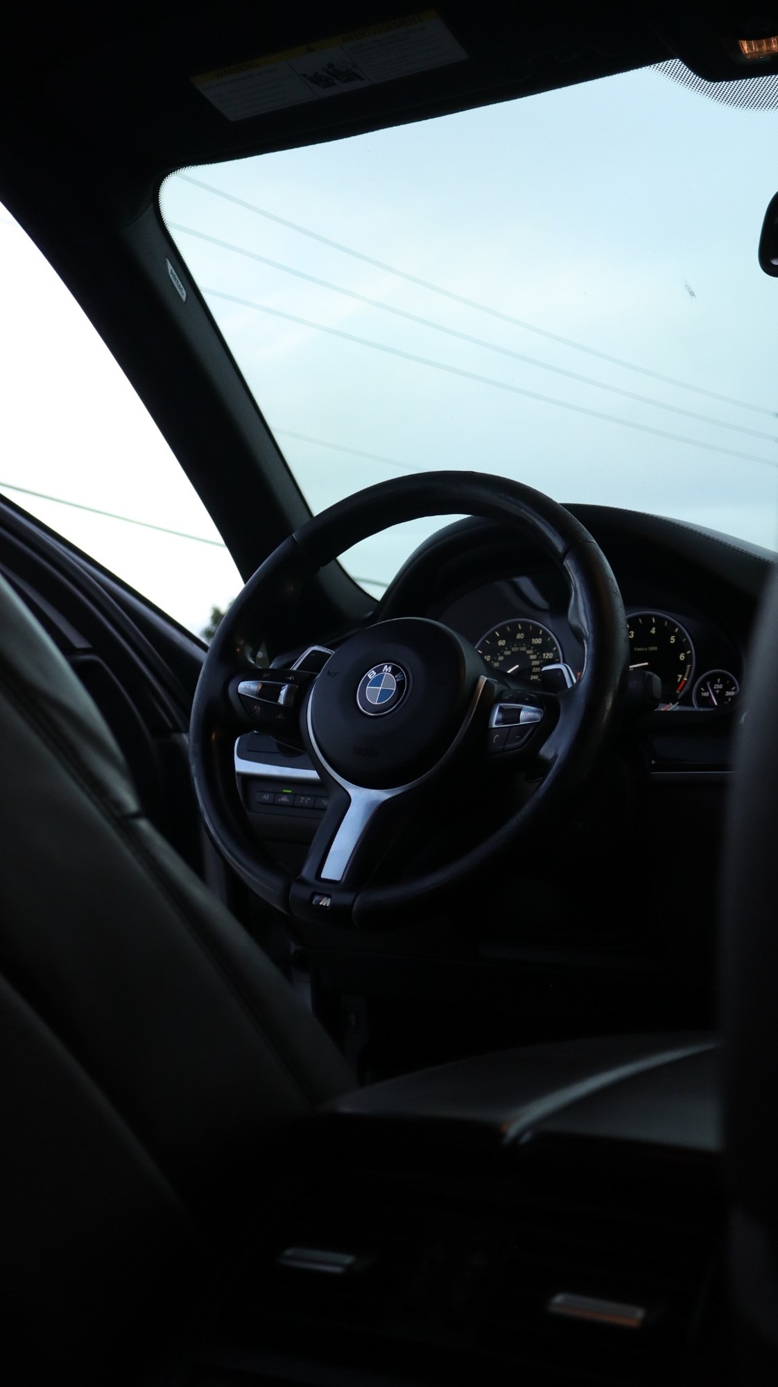 BMW steering wheel and dark interior